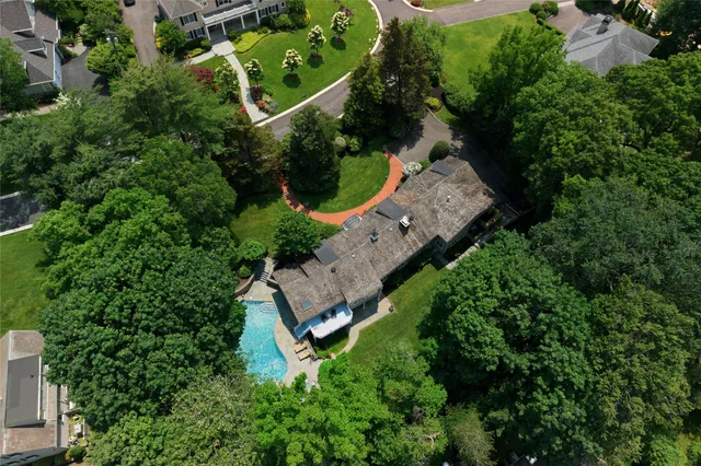 an aerial view of a house with a yard and outdoor seating