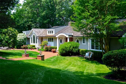 a front view of a house with a yard and porch