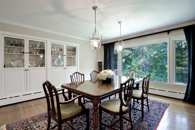 a view of a dining room with furniture window and wooden floor