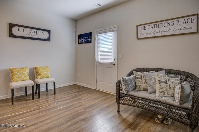 a bedroom with furniture and a wooden floor