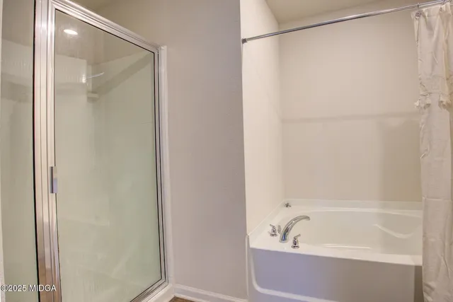 a bathroom with a bathtub and a shower