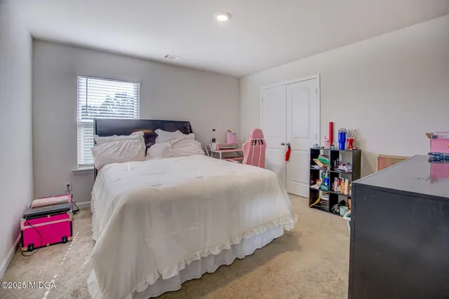 a bed room with a bed and a chandelier