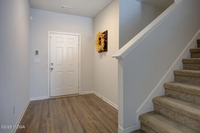 a view of entryway with stairs and wooden floor