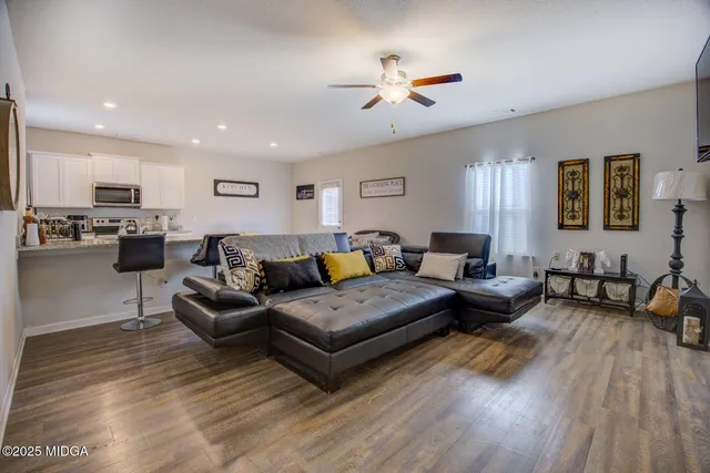 a living room with furniture and painting on the wall