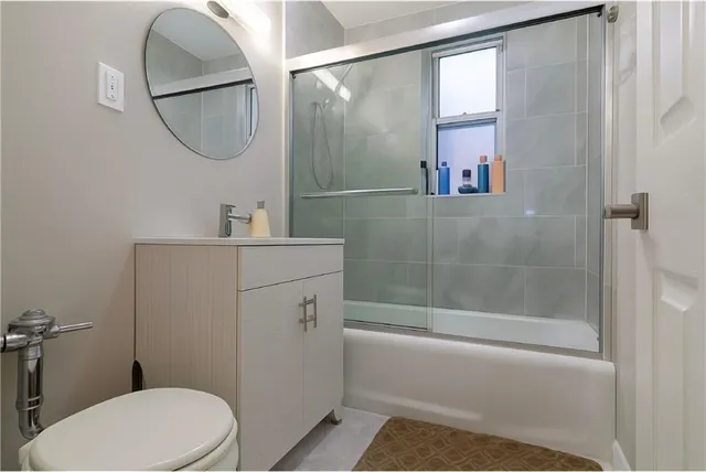 a bathroom with a sink toilet and a mirror