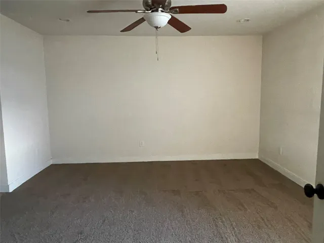 en empty room with a fan