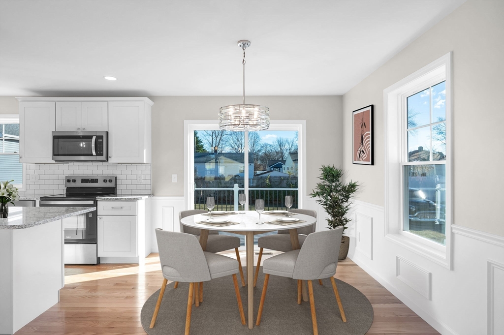 39 Wallace Street Springfield, MA 01119 - Photo 11 of 41 a dining room with furniture a chandelier and wooden floor