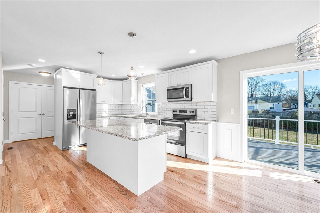 39 Wallace Street Springfield, MA 01119 - Photo 17 of 41 a kitchen with white cabinets and appliances