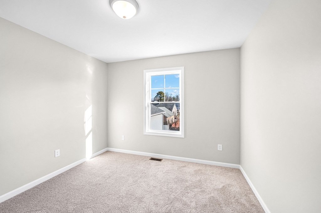 39 Wallace Street Springfield, MA 01119 - Photo 32 of 41 a view of an empty room with a window