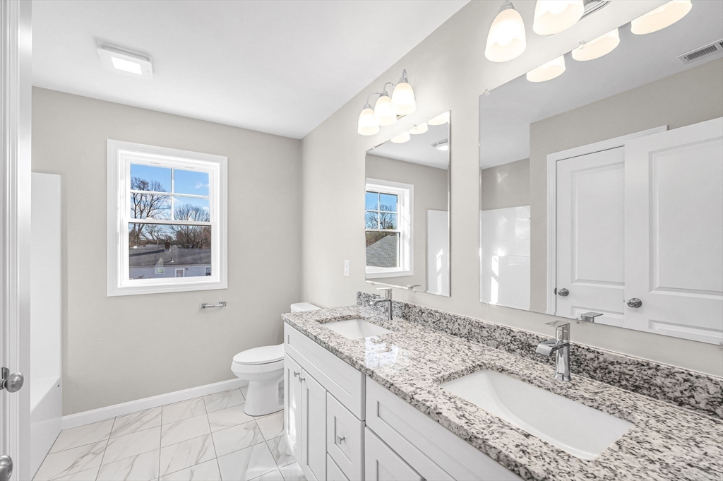 39 Wallace Street Springfield, MA 01119 - Photo 34 of 41 a bathroom with a granite countertop double vanity sink a mirror and a toilet