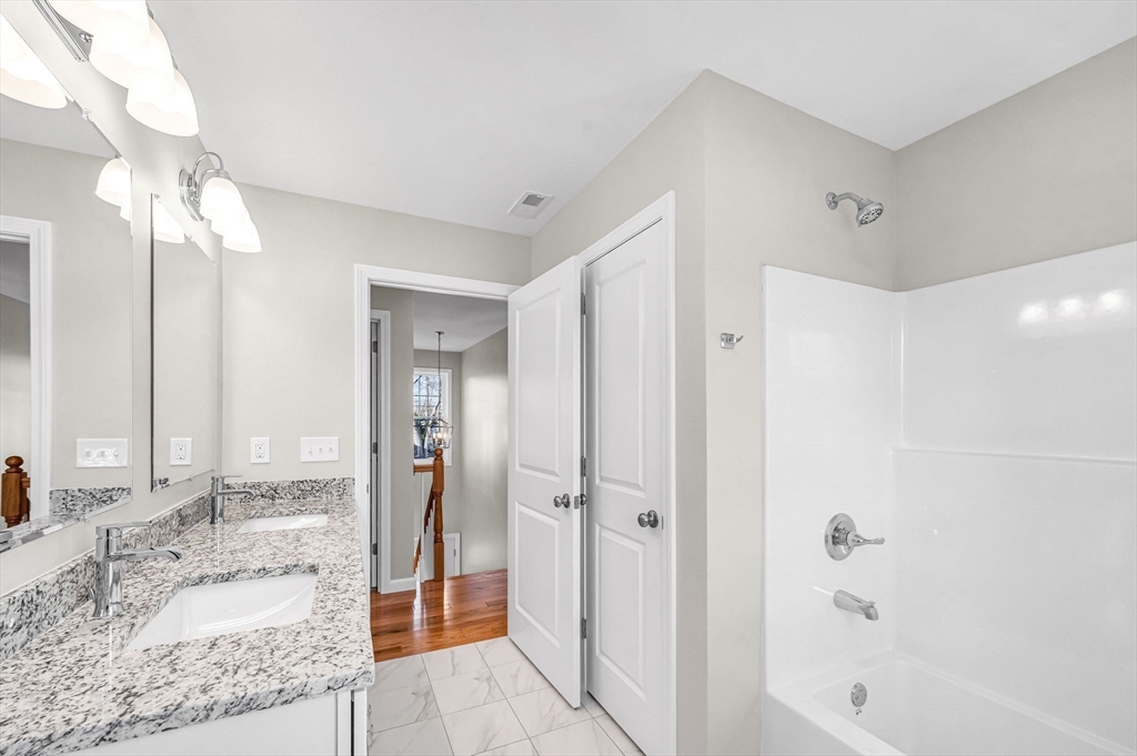 39 Wallace Street Springfield, MA 01119 - Photo 35 of 41 a bathroom with a granite countertop sink mirror and shower