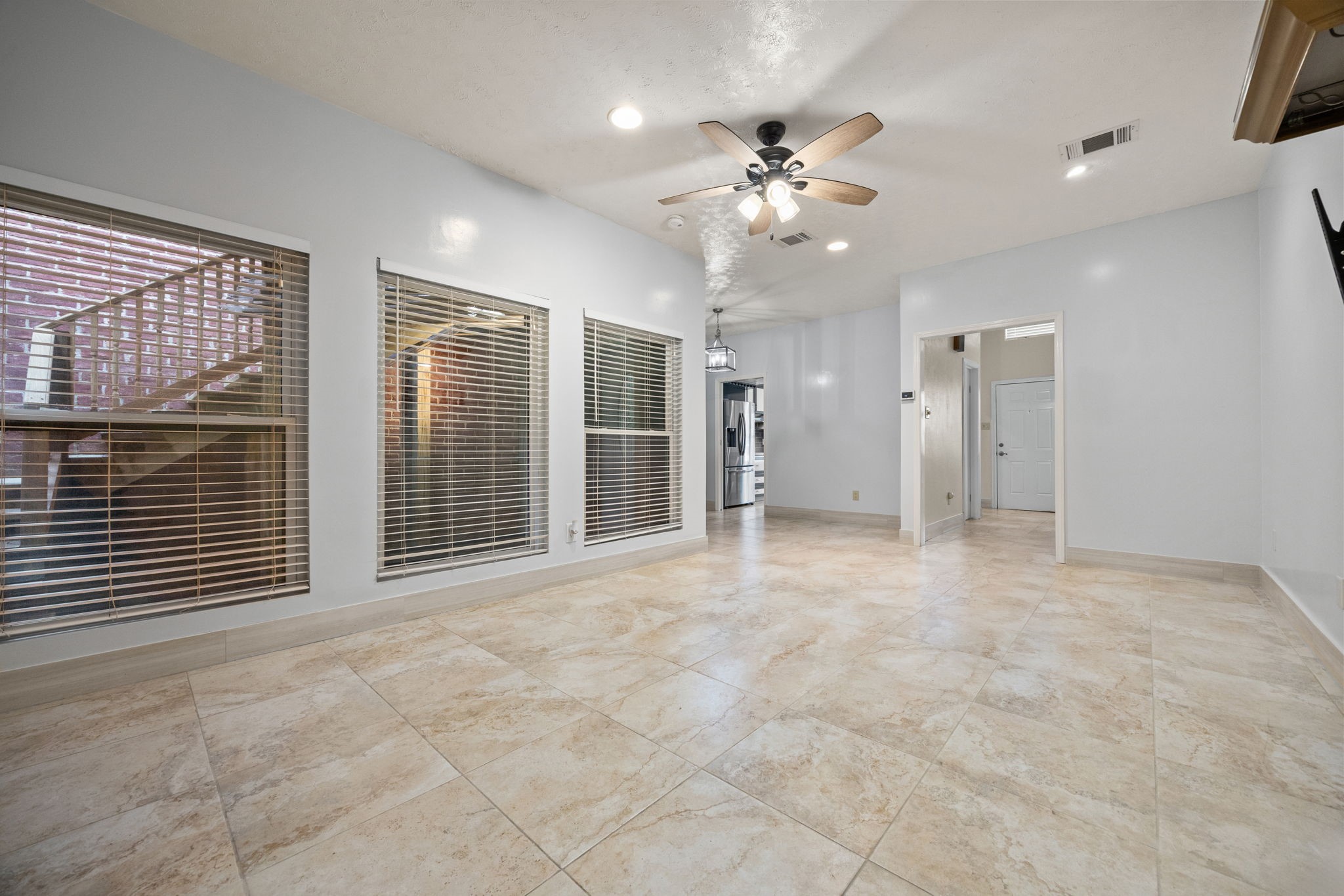 7447 Cambridge Street, Unit 117 Houston, TX 77054 - Photo 11 of 38 a view of an empty room with chandelier fan