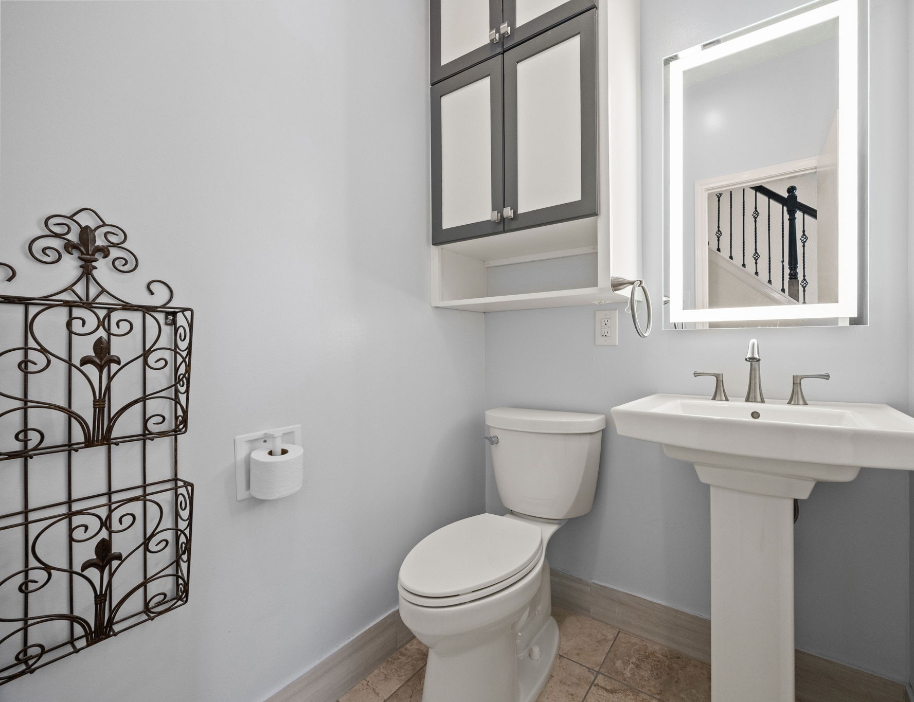 7447 Cambridge Street, Unit 117 Houston, TX 77054 - Photo 12 of 38 a bathroom with a toilet sink and mirror