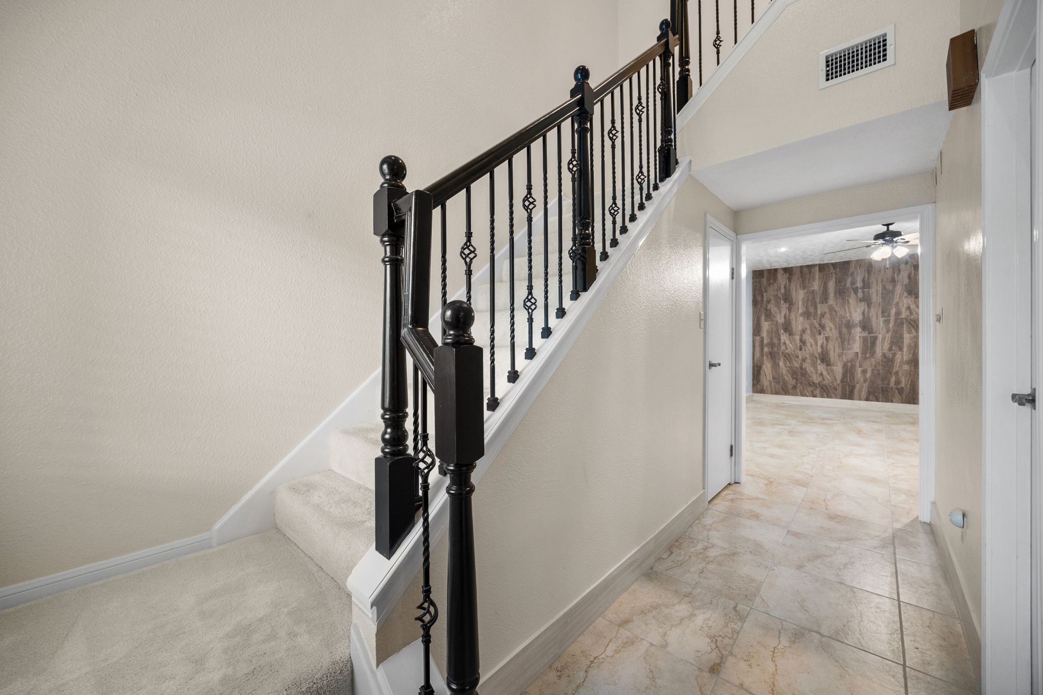 7447 Cambridge Street, Unit 117 Houston, TX 77054 - Photo 2 of 38 a view of staircase with wooden floor and white walls