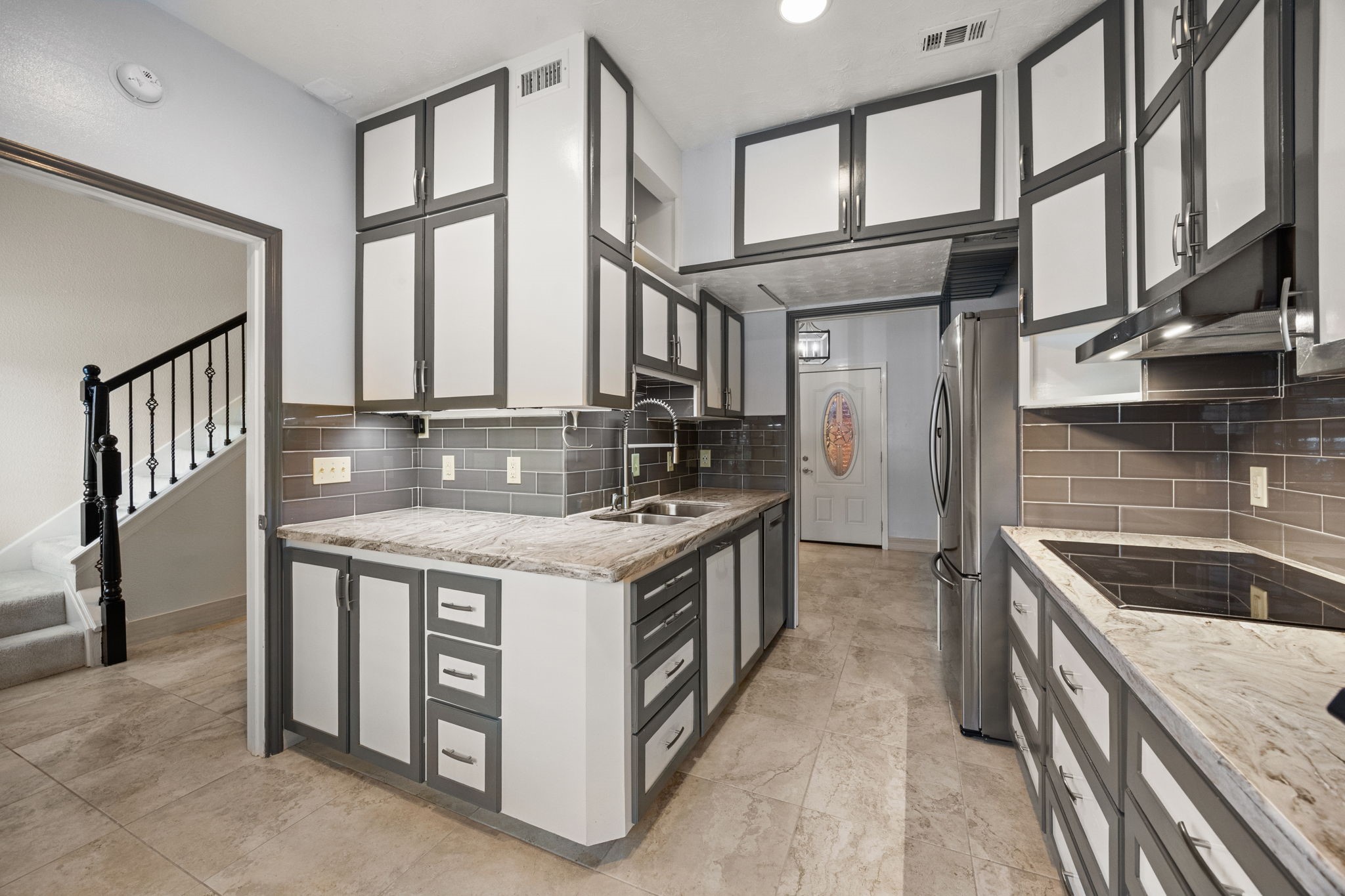 7447 Cambridge Street, Unit 117 Houston, TX 77054 - Photo 3 of 38 a kitchen with stainless steel appliances granite countertop a stove and a sink