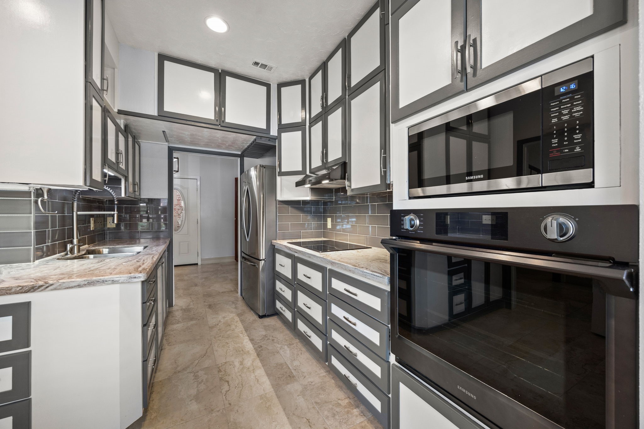 7447 Cambridge Street, Unit 117 Houston, TX 77054 - Photo 6 of 38 a kitchen with stainless steel appliances granite countertop a stove and a microwave