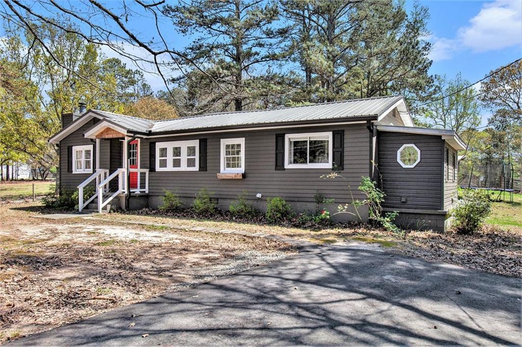 5760 Tyree Road Winston, GA 30187 - Photo 1 of 1 a front view of a house with garden