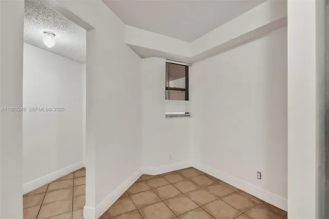 a view of a house with large space and a car park in front of it