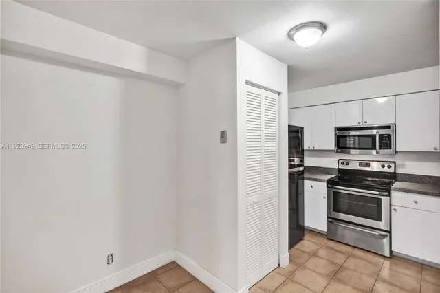 a kitchen with a refrigerator and a sink
