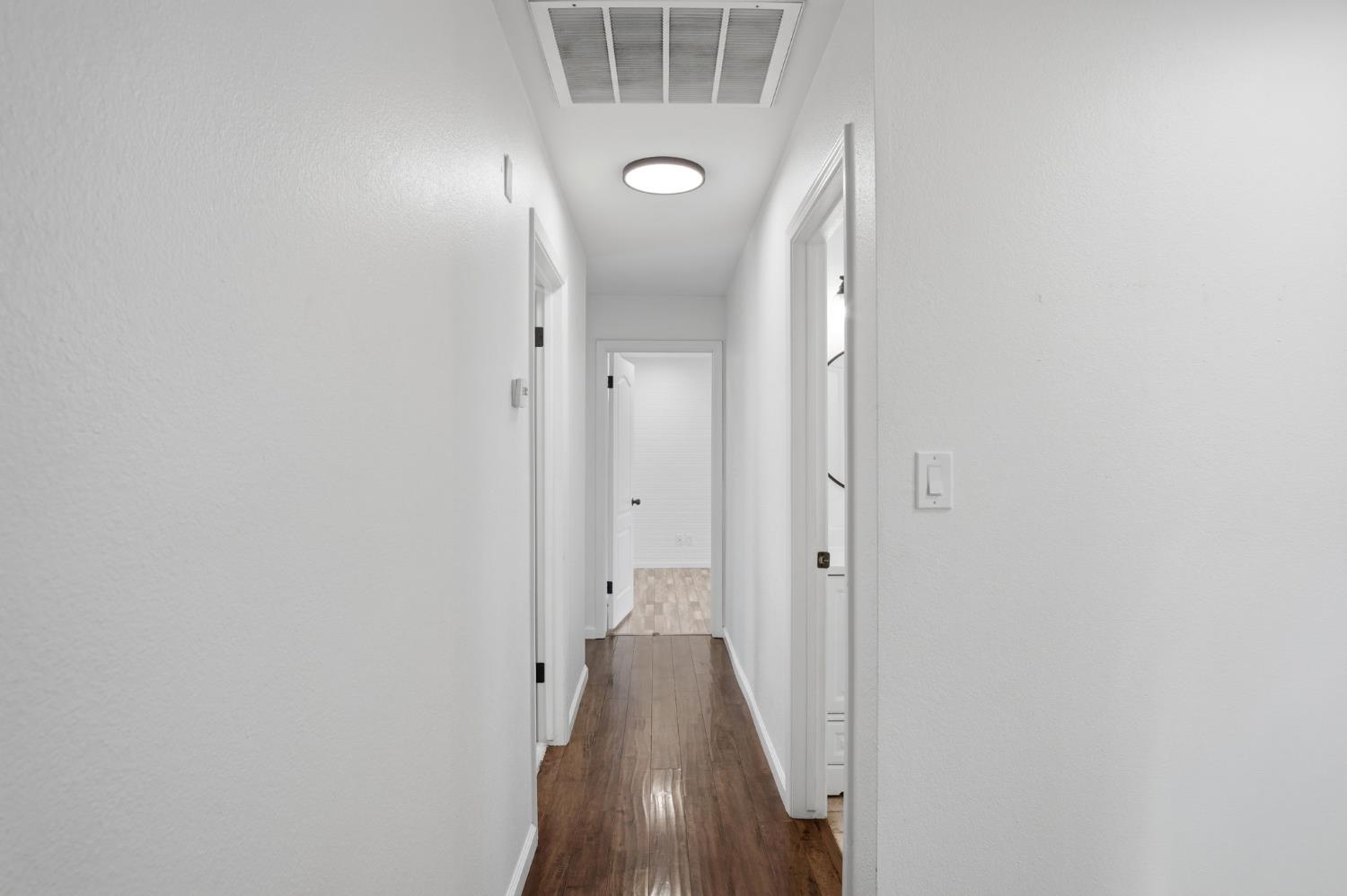 680 Sherri Way Turlock, CA 95382 - Photo 12 of 35 a view of a hallway with wooden floor and closet