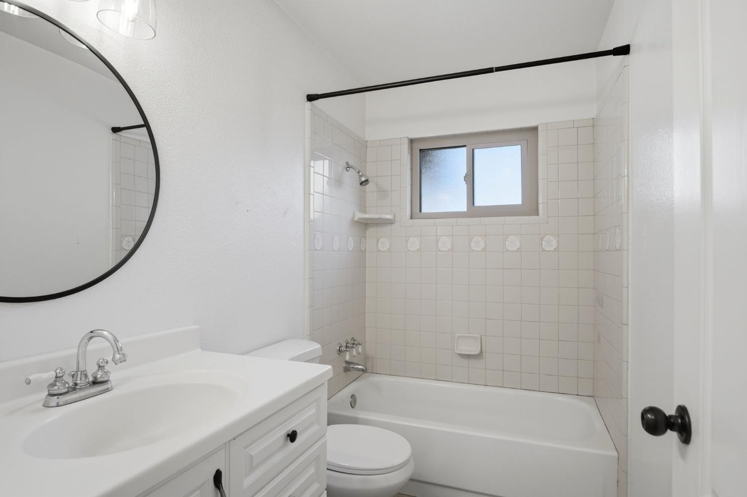 680 Sherri Way Turlock, CA 95382 - Photo 13 of 35 a bathroom with a bathtub shower sink vanity and a toilet