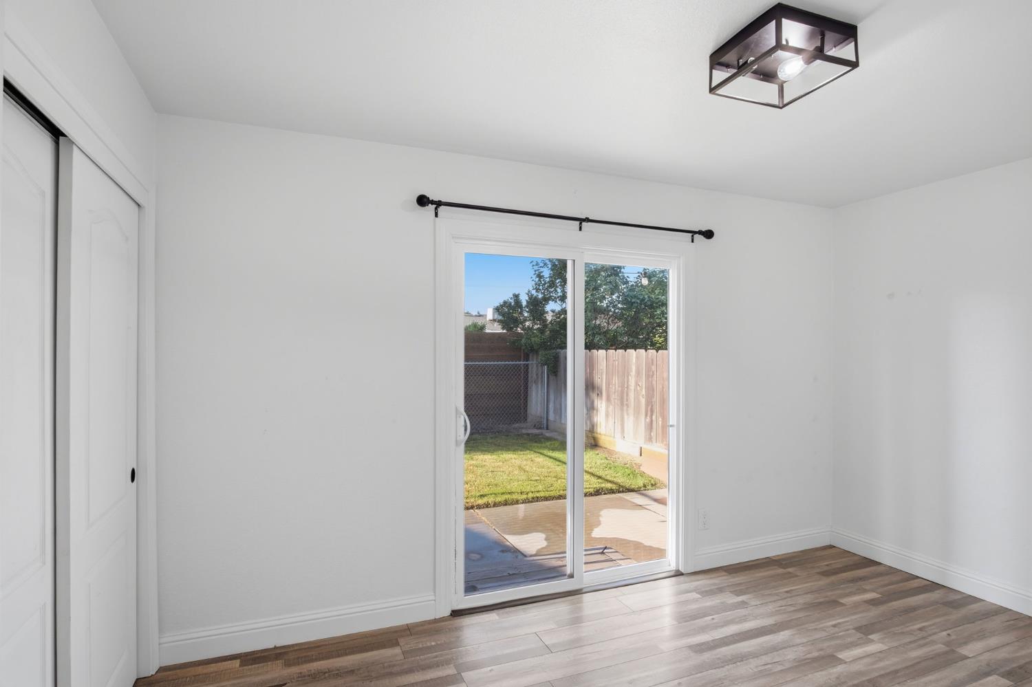 680 Sherri Way Turlock, CA 95382 - Photo 15 of 35 a view of an empty room with wooden floor and a window