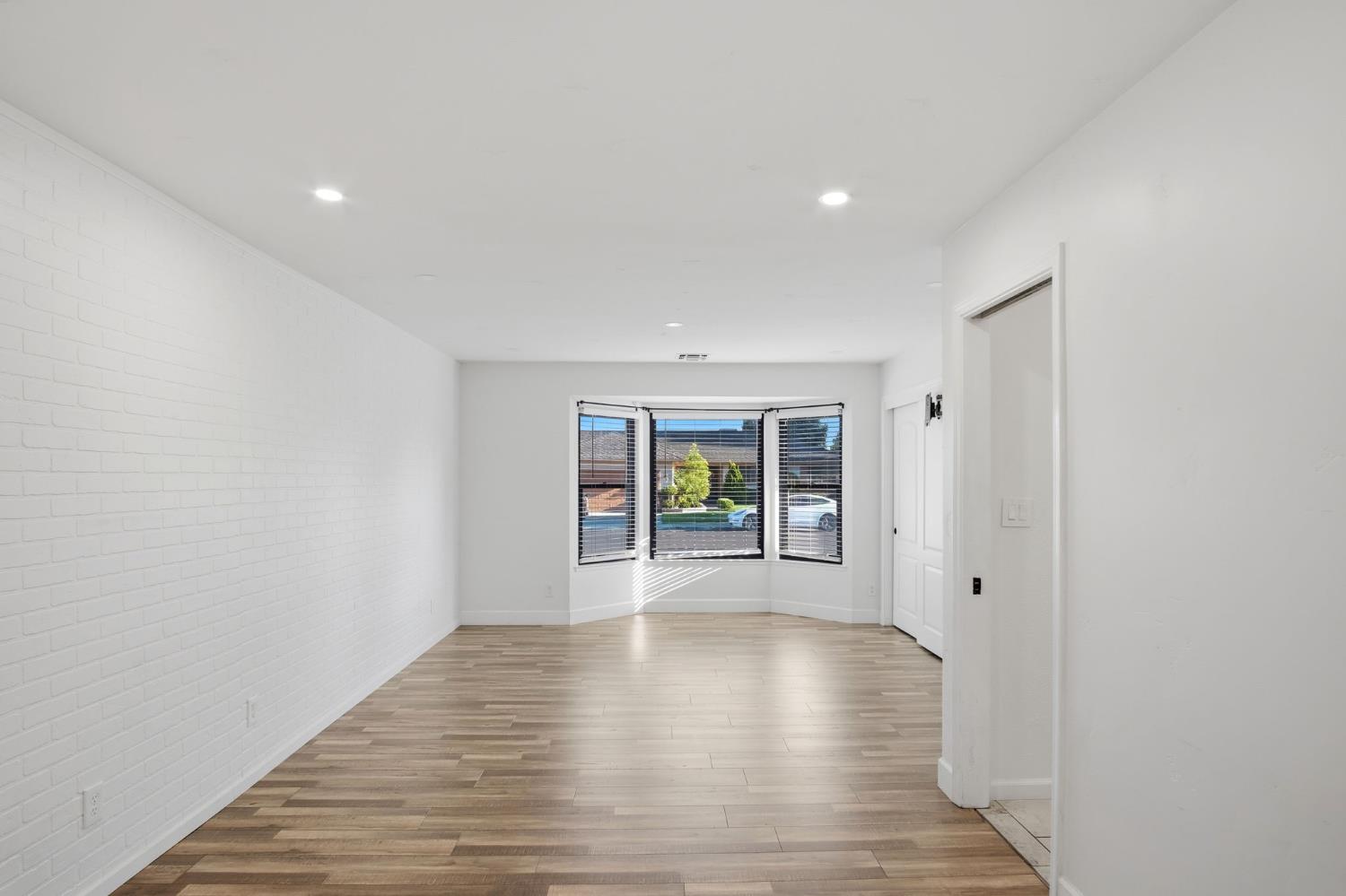 680 Sherri Way Turlock, CA 95382 - Photo 16 of 35 a view of an empty room with wooden floor and a window