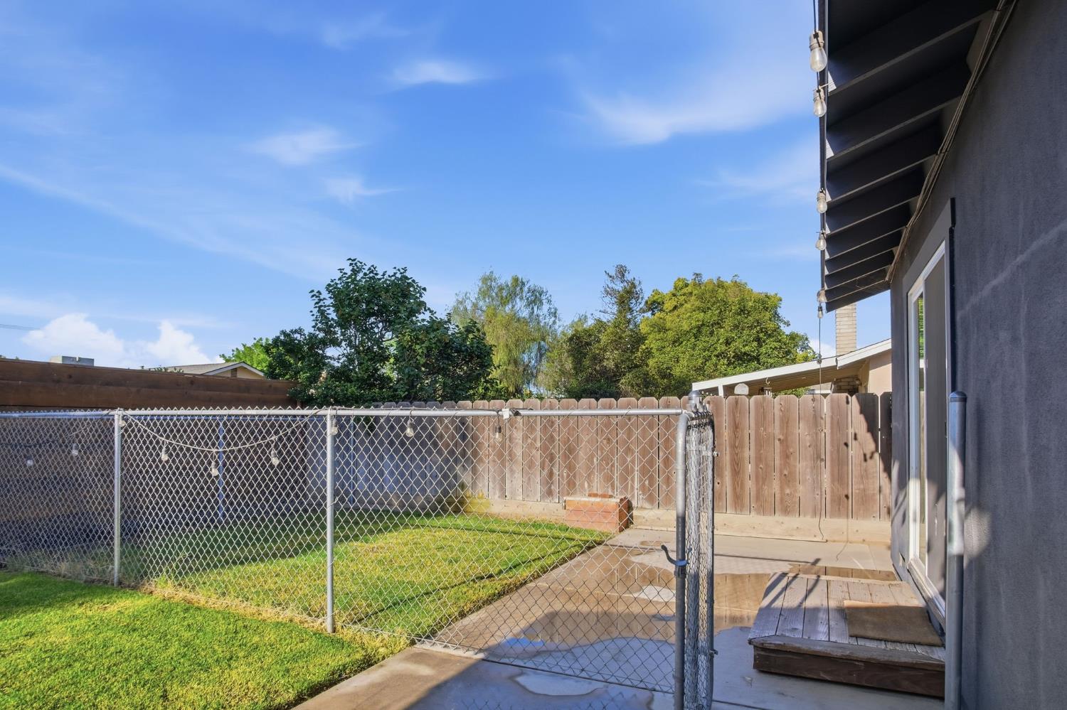 680 Sherri Way Turlock, CA 95382 - Photo 24 of 35 a view of a deck with a big yard and potted plants