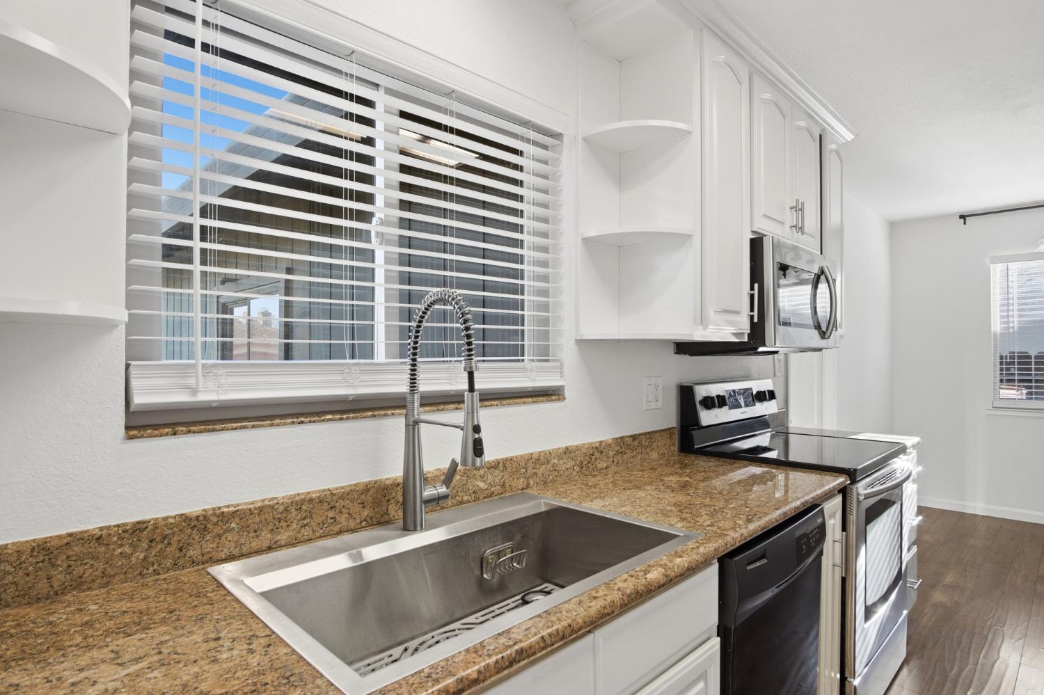 680 Sherri Way Turlock, CA 95382 - Photo 3 of 35 a kitchen that has a sink and a stove in it