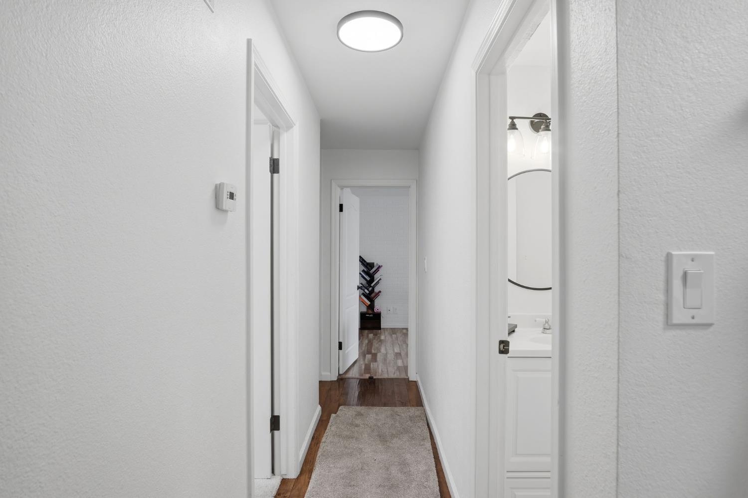680 Sherri Way Turlock, CA 95382 - Photo 32 of 35 a view of a hallway with wooden floor and closet