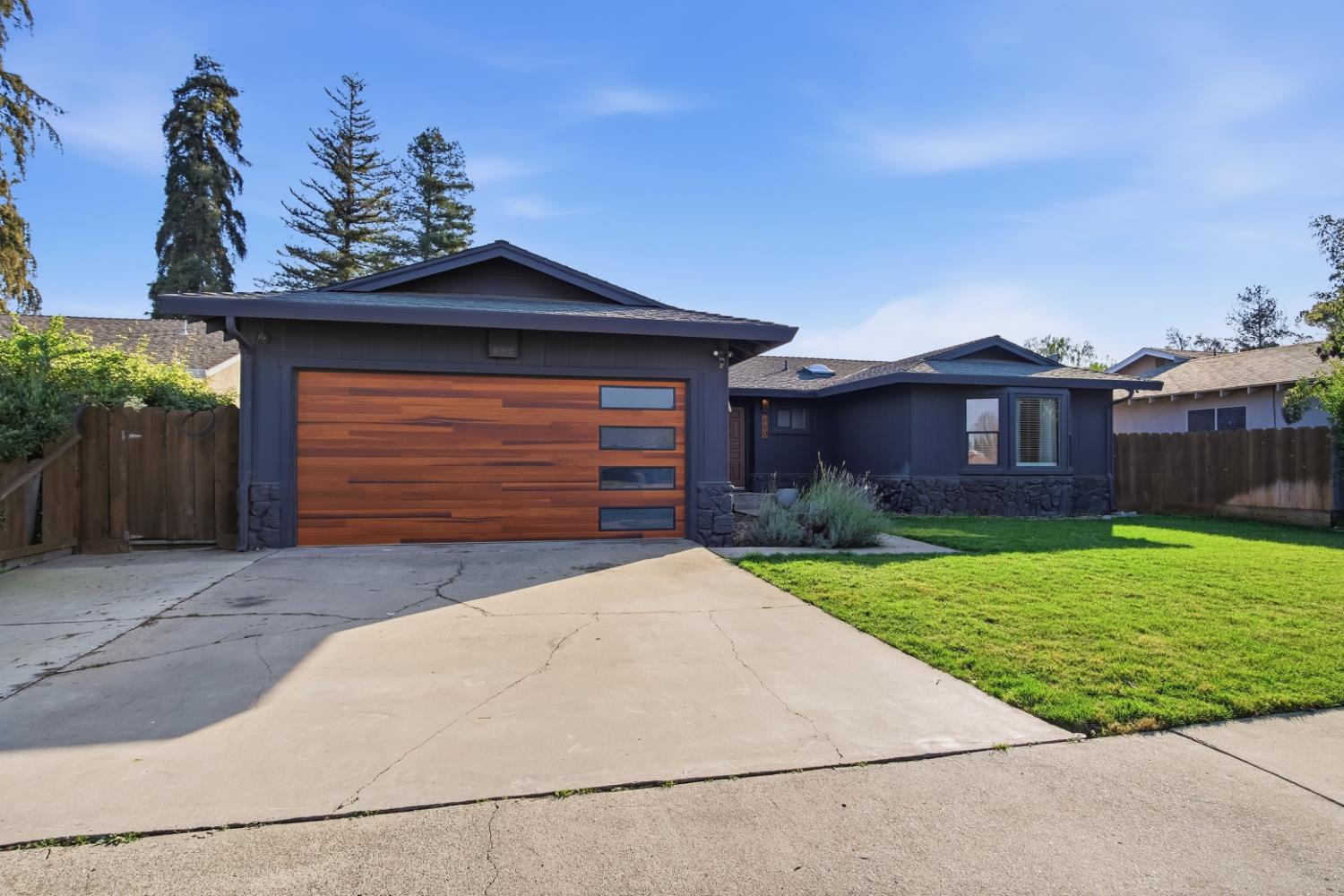 680 Sherri Way Turlock, CA 95382 - Photo 34 of 35 a front view of a house with a yard and garage