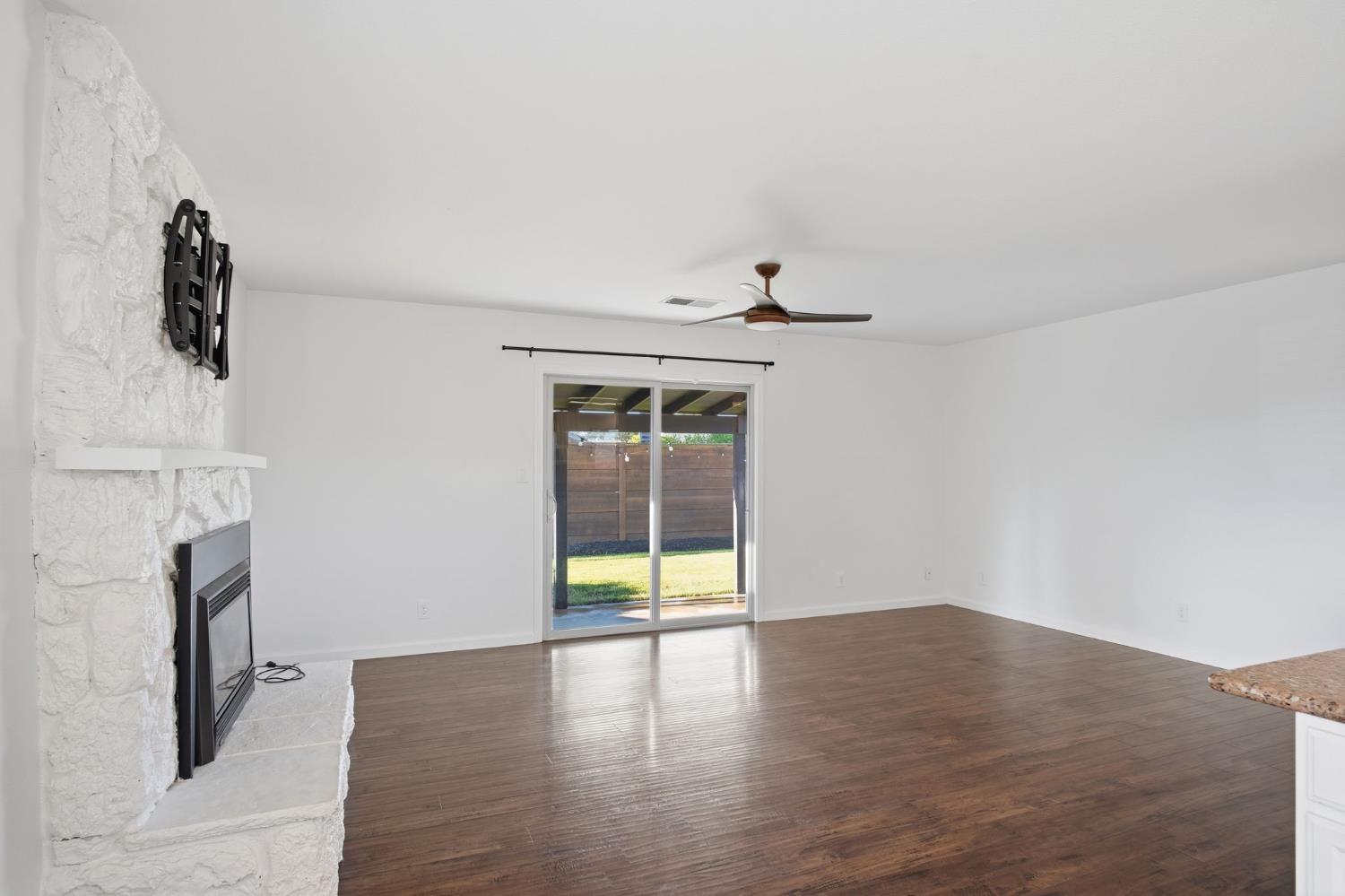 680 Sherri Way Turlock, CA 95382 - Photo 8 of 35 a view of an empty room with wooden floor and a fireplace