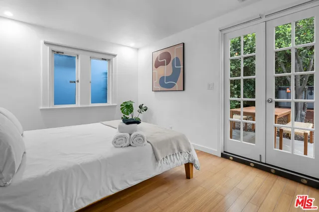 a bedroom with a large bed and a large window