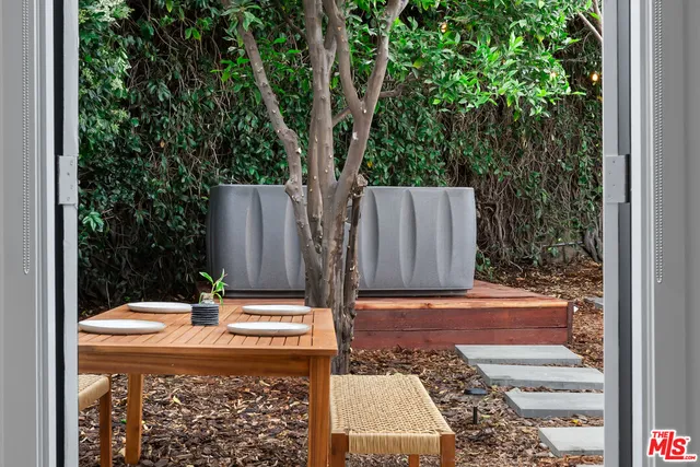 a view of backyard with a barbeque and large trees