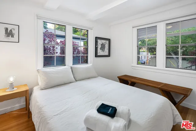 a bedroom with a large bed and a large window