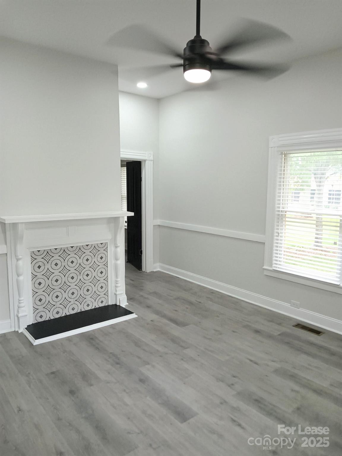 238 South Main Street, Unit A Davidson, NC 28036 - Photo 2 of 11 an empty room with wooden floor cabinet and windows