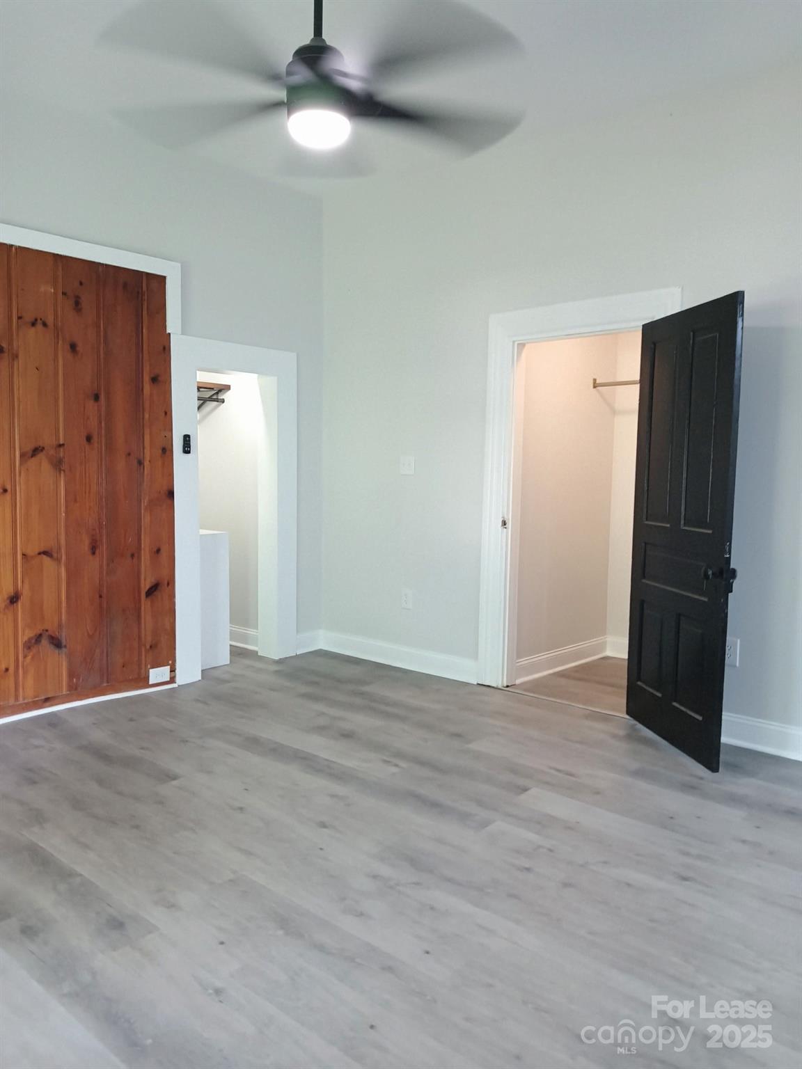 238 South Main Street, Unit A Davidson, NC 28036 - Photo 3 of 11 a view of an empty room with wooden floor and a cabinet