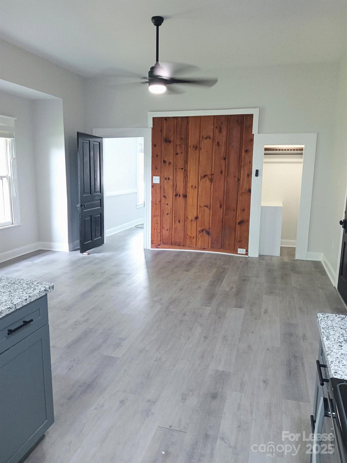 238 South Main Street, Unit A Davidson, NC 28036 - Photo 4 of 11 an empty room with wooden floor cabinet and windows