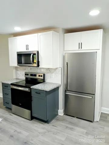 a kitchen with a refrigerator stove and microwave