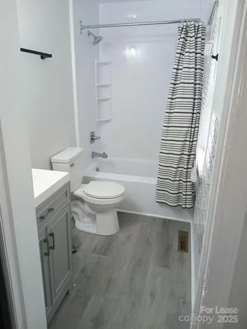 a bathroom with a shower toilet and sink