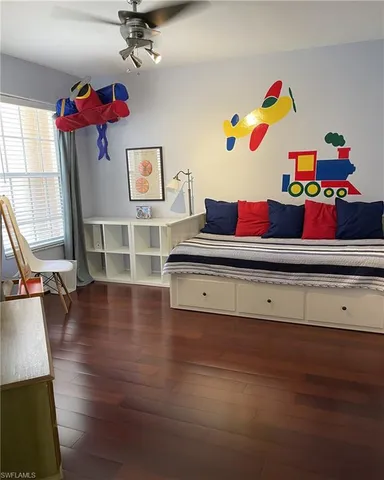 a view of a workspace with furniture and wooden floor