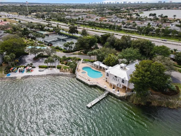 an aerial view of residential houses with outdoor space and river