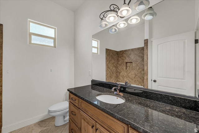 691 Rainier Drive St. George, UT 84770 - Photo 10 of 24 Bathroom featuring vanity, light tile patterned flooring, and tiled shower