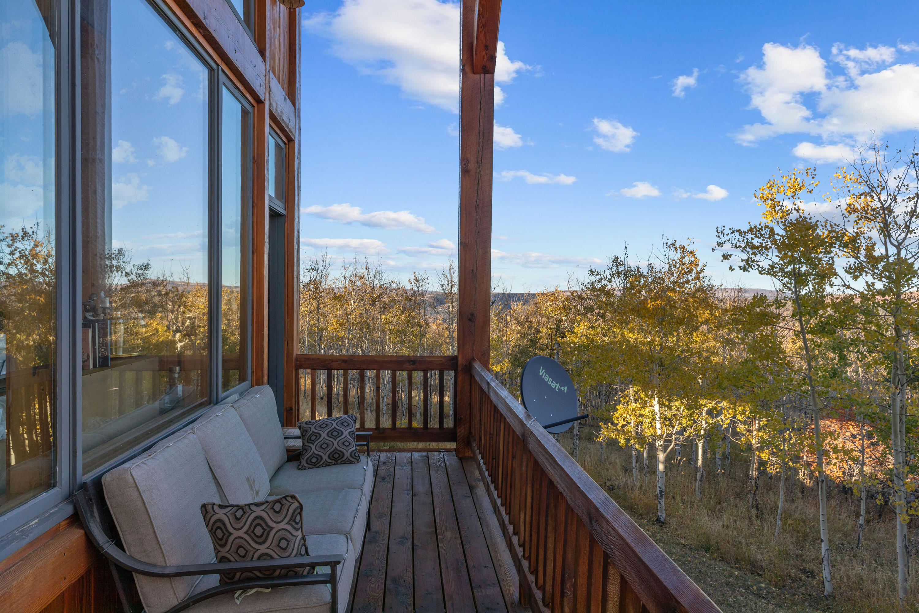 1036 Harcourt Trail Placerville, CO 81430 - Photo 13 of 44 a balcony with wooden floor and outdoor seating