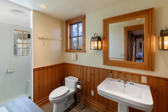 a bedroom with a bed and a potted plant