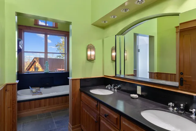 a bedroom with a bed and a dresser next to a window