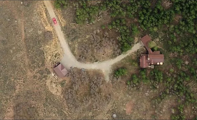 a aerial view of a house with a yard