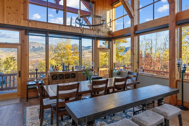 a dining room with furniture a chandelier and wooden floor