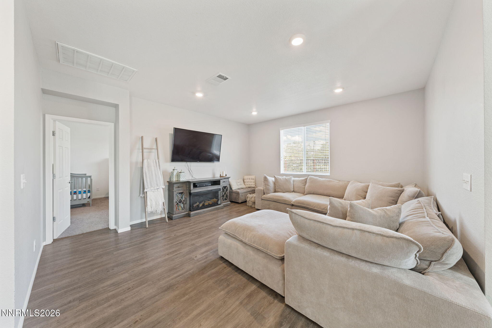 9708 Sea Glass Drive Reno, NV 89506 - Photo 23 of 51 a living room with furniture and a flat screen tv