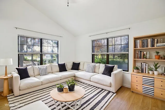 a living room with furniture and a book shelf